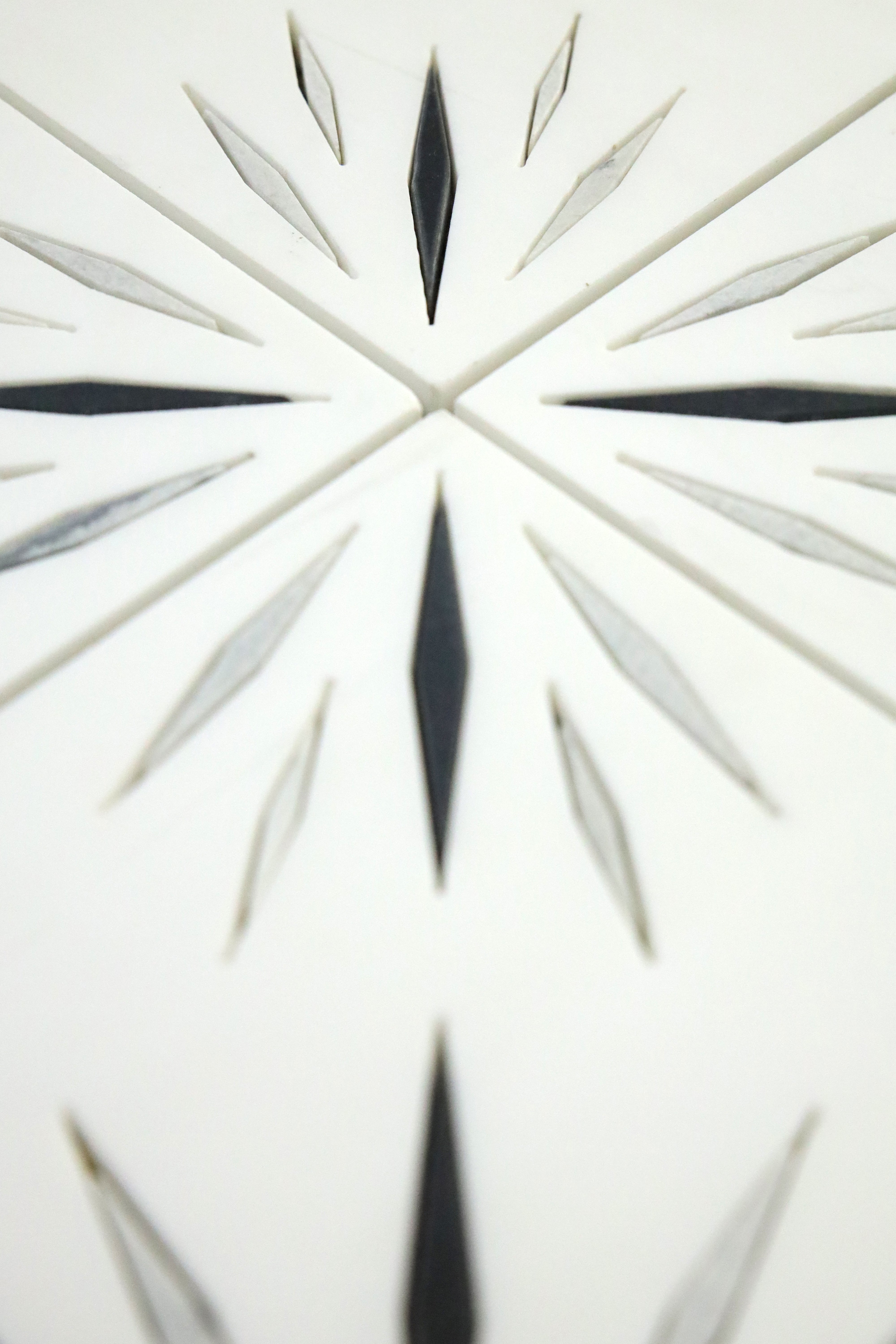Geometric marble mosaic tile with black and white contrast pattern detail